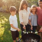 family-standing-near-barbecue-roasting-marshmallow-park.jpg